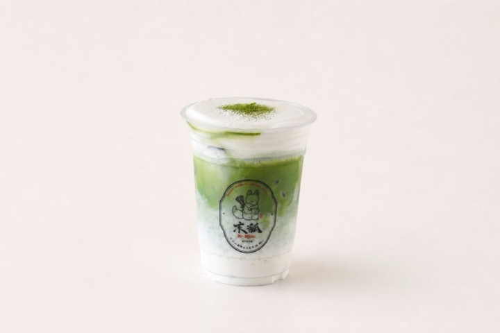 Matcha Cream Latte Iced matcha latte under a thick cap of cream foam dusted with matcha powder