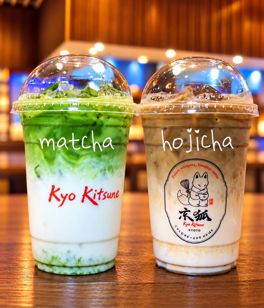 Matcha and hojicha lattes Two tall Kyo Kitsune cups labelled matcha and hojicha, layered vivid green and roasted-tea brown over milk