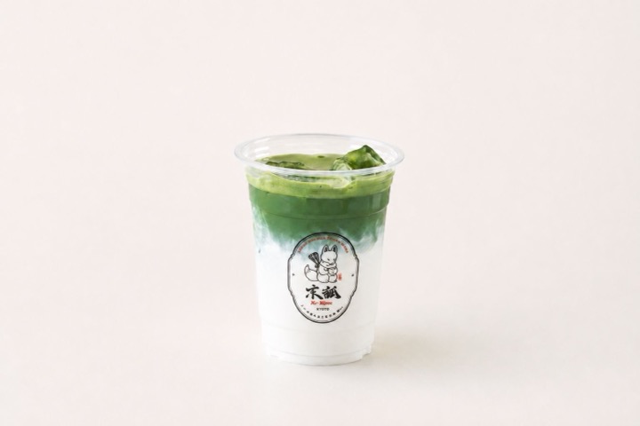 Matcha Latte Iced Uji matcha latte layered over milk in a clear Kyo Kitsune cup