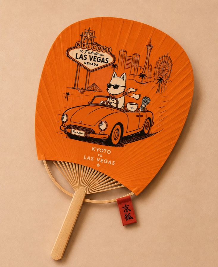 Kyoto to Las Vegas hand fan Orange Japanese hand fan printed with a fox driving a convertible past Las Vegas landmarks